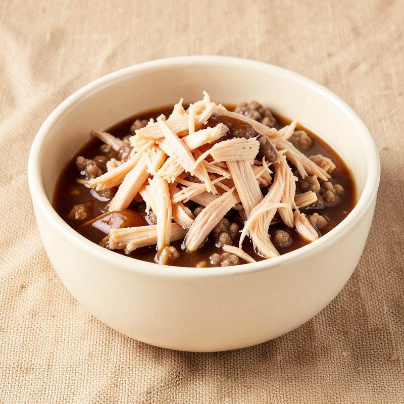 Shredded Chicken in Gravy Wet Food — Shredded chicken in gravy, sold in six- and twelve-can cases.